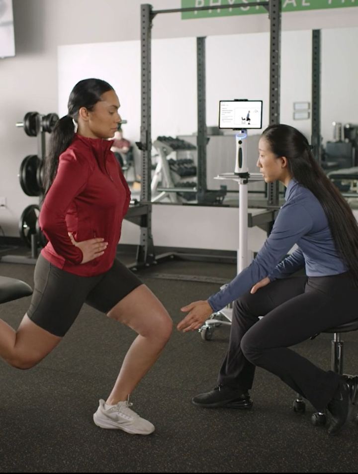 Physical therapist guiding a patient through an exercise with PT Copilot